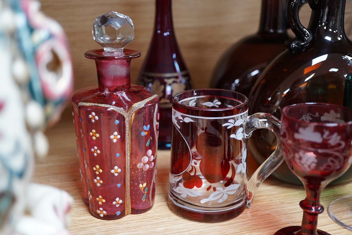 A collection of coloured glass flagons, glasses and bottles etc. (18). Tallest decanter and stopper 25cm high.